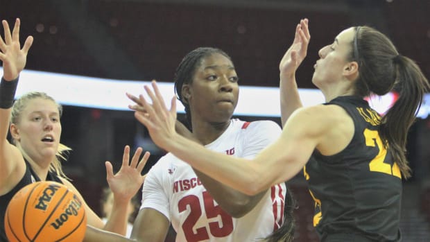 WisconIsin's Serah Williams is double teamed by Iowa's Caitlin Clark (22) and Monika Czinano at the Kohl Center in Madison, Wis. on Sunday Dec. 4, 2022. Uwwomen Iowa Dec 4 2022 2  